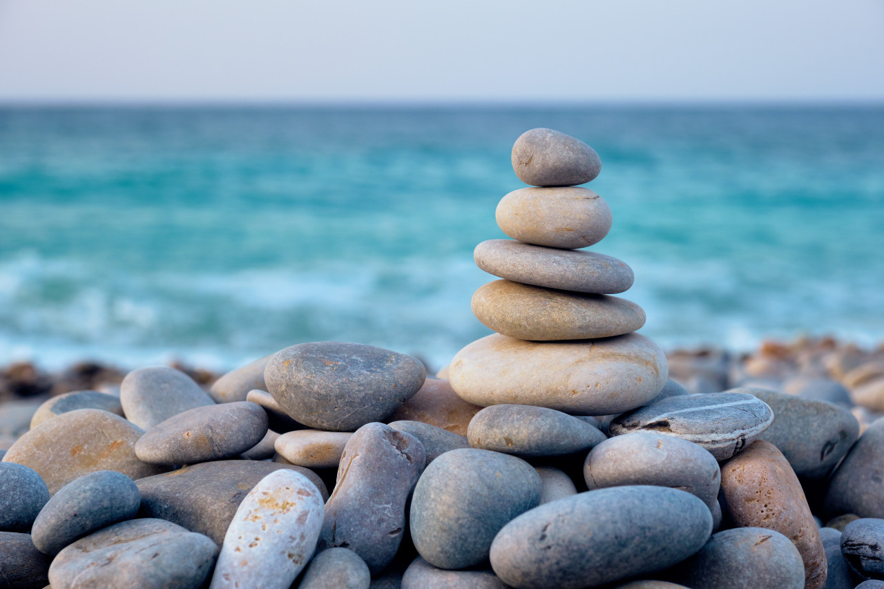 stones stacked on top of one another by the beach