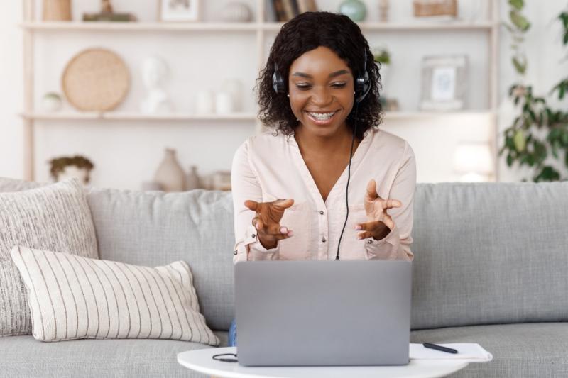 a woman wearing headphones talking to a computer