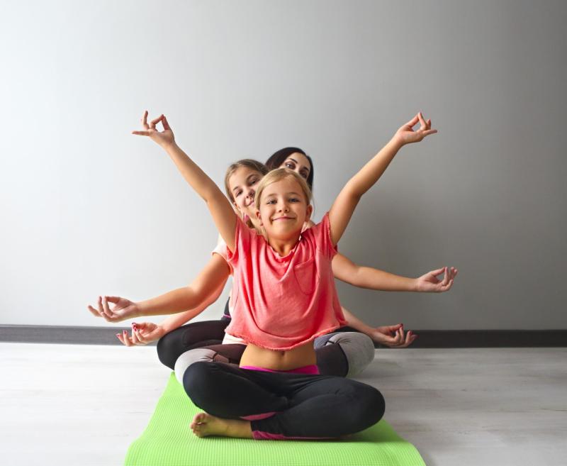 kids in a line doing yoga poses