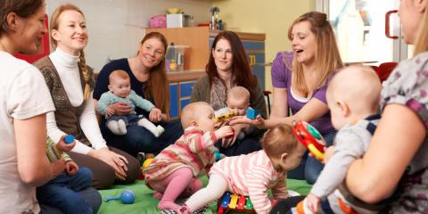 a group of mothers and their babies in a circle socializing